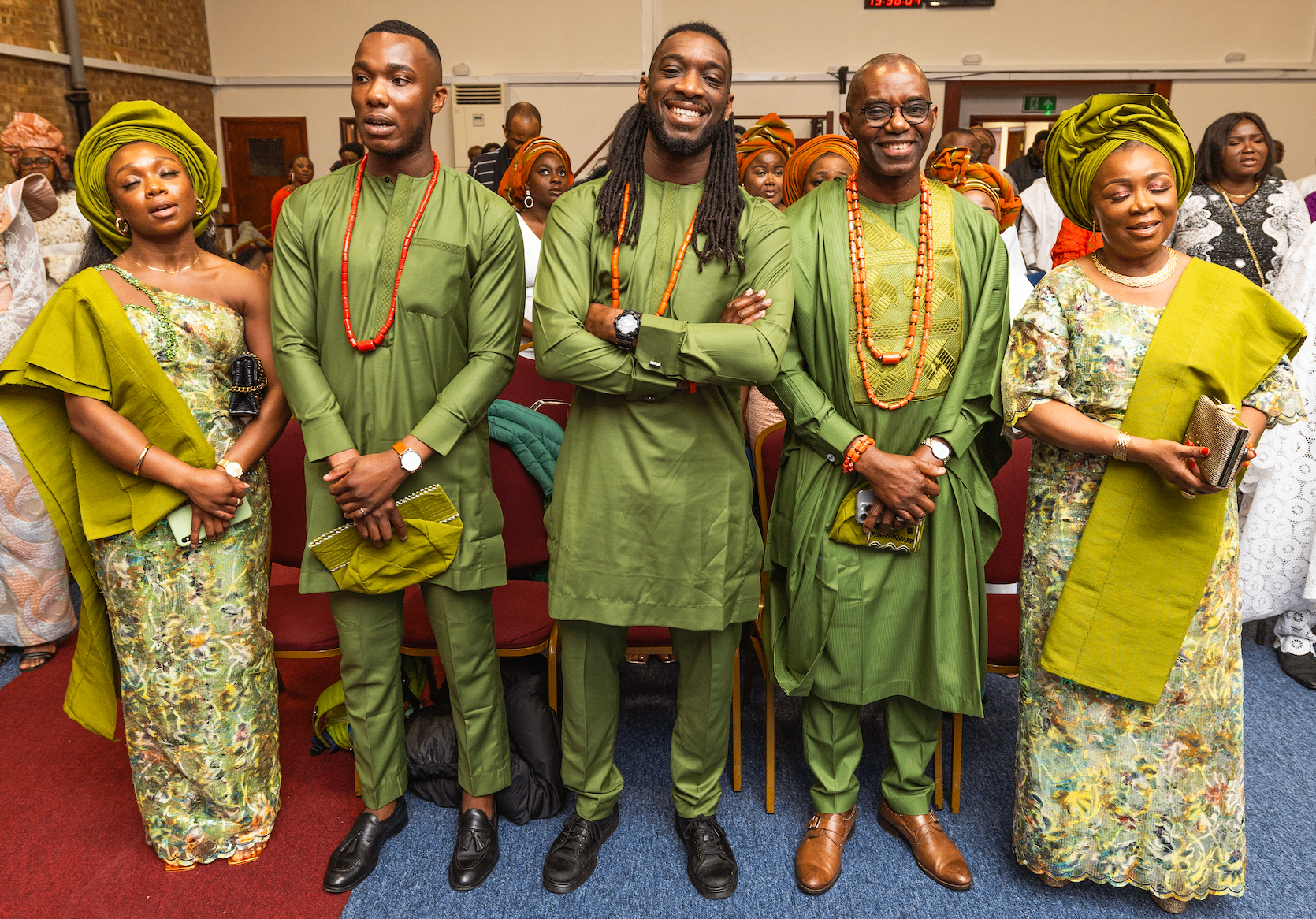 The Akinwunmi family dressed in matching green traditional attire at a celebration